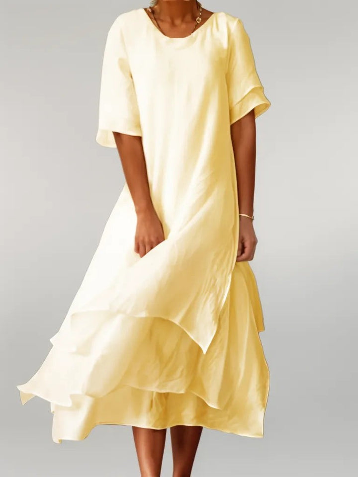 Pale yellow layered hem midi dress featuring flutter sleeves and flowing skirt