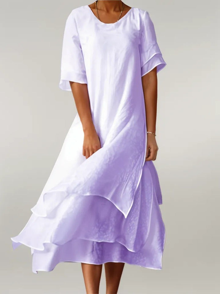 Lilac layered hem midi dress showing flowing ruffled skirt and round neck
