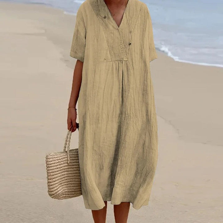 Sage beige crinkled linen midi dress with short sleeves, beach setting