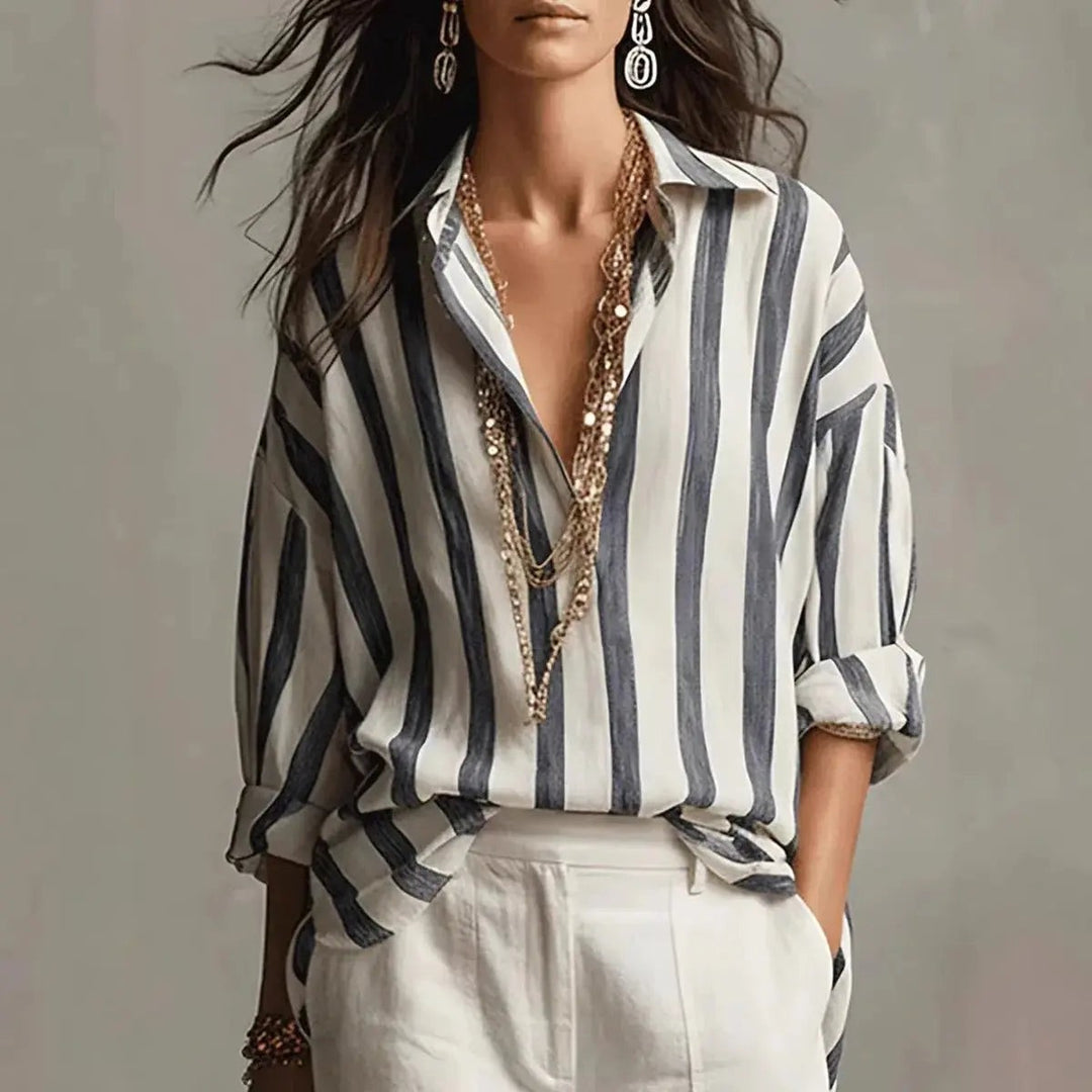 Navy and white vertical striped blouse with collared V-neck and rolled sleeves