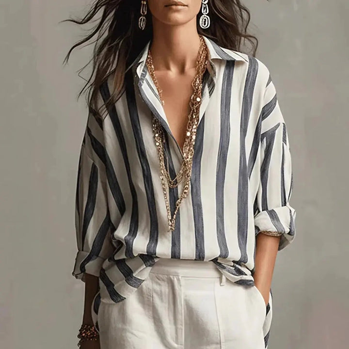 Navy and white vertical striped blouse with collared V-neck and rolled sleeves