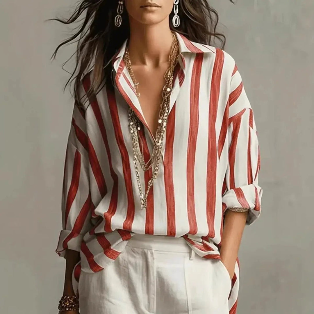 Red and white vertical striped collared blouse worn with white tailored trousers
