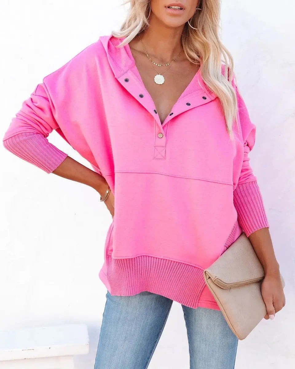 Bright pink hooded sweatshirt with popper neckline and ribbed hem