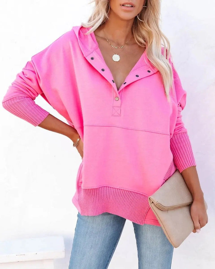 Bright pink hooded sweatshirt with popper neckline and ribbed hem