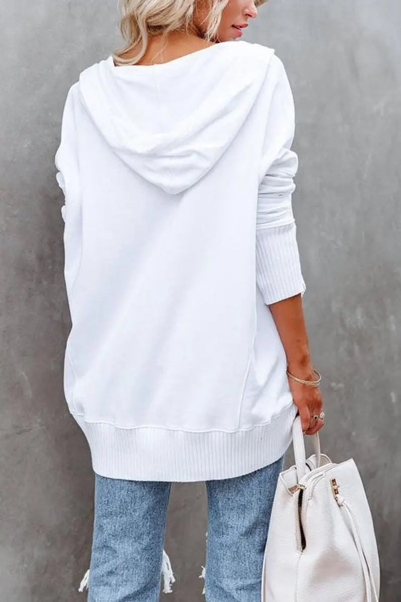 Rear view of white longline hoodie showing ribbed hem and relaxed fit