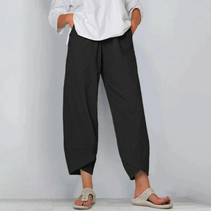 Black linen-blend cross-hem trousers styled with a white shirt and sandals