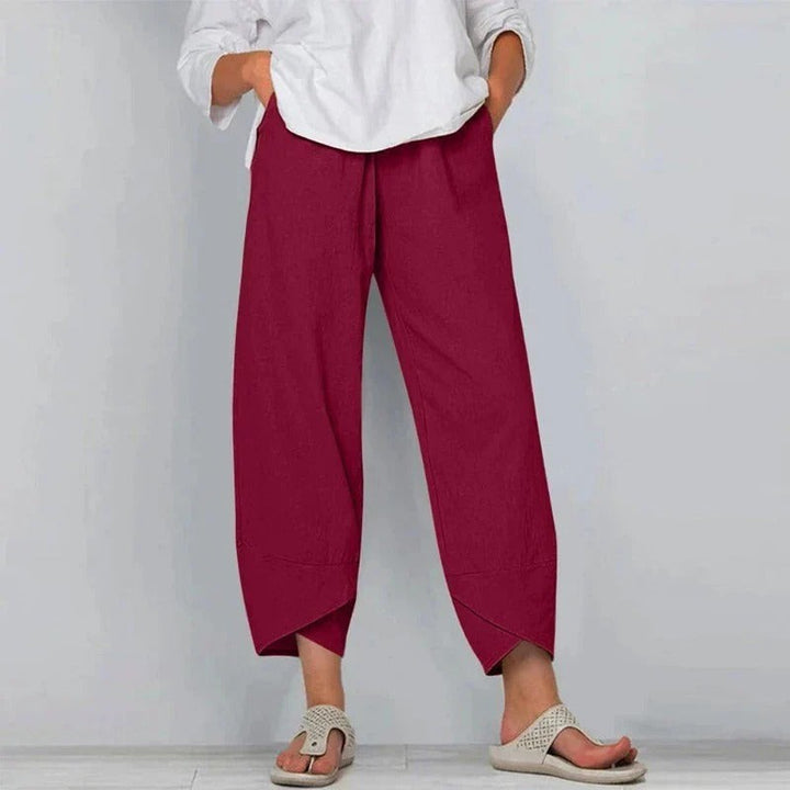 Burgundy wide-leg lantern trousers with tapered cross-hem and elastic waist