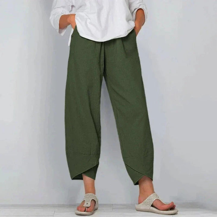 Khaki green linen-style trousers showing relaxed fit and cropped cross-hem