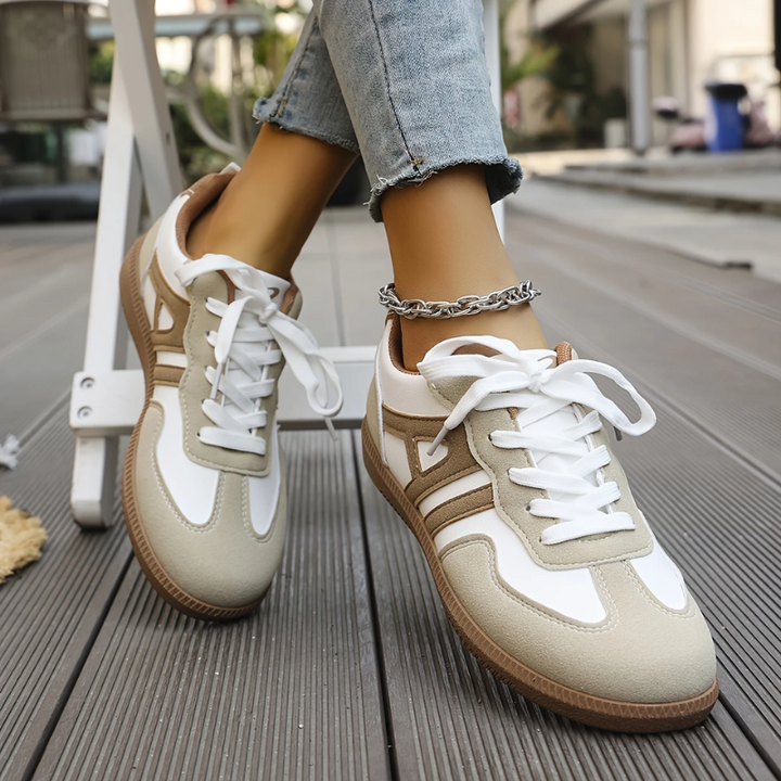 White lace-up trainers with beige suede panels and tan racing stripes
