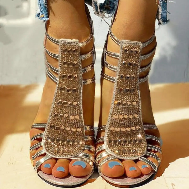 Front view of gold rhinestone strappy sandals with caged straps