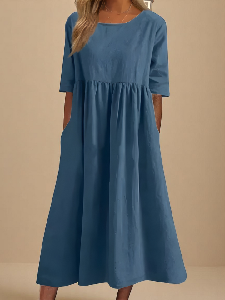Teal blue midi dress with round neckline and mid-length sleeves