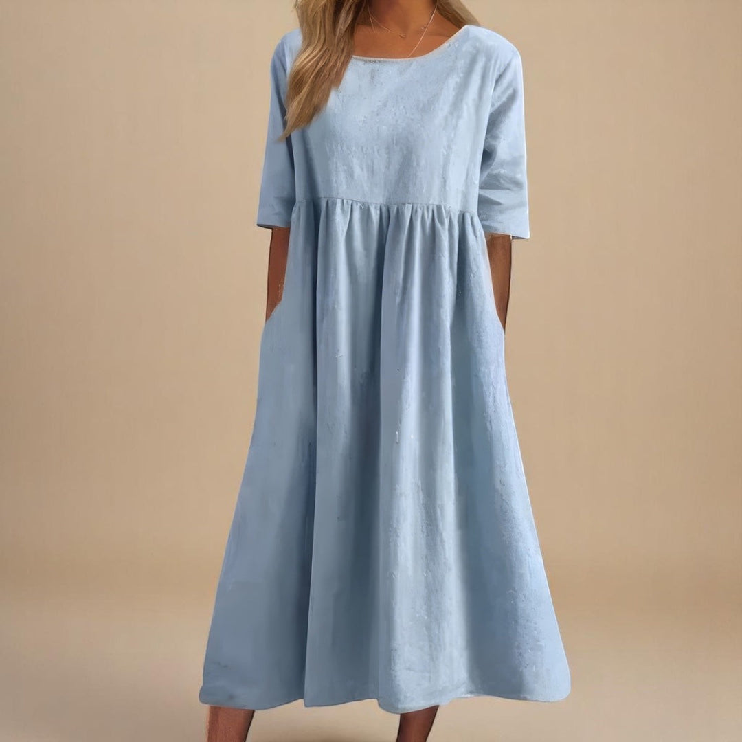 Pale blue midi dress with gathered waist and loose flowing skirt