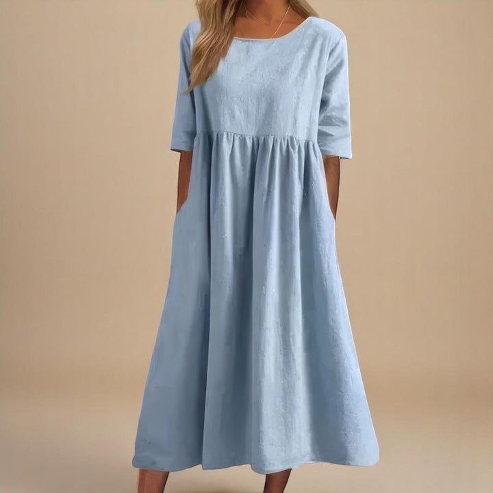 Pale blue midi dress with gathered waist and loose flowing skirt
