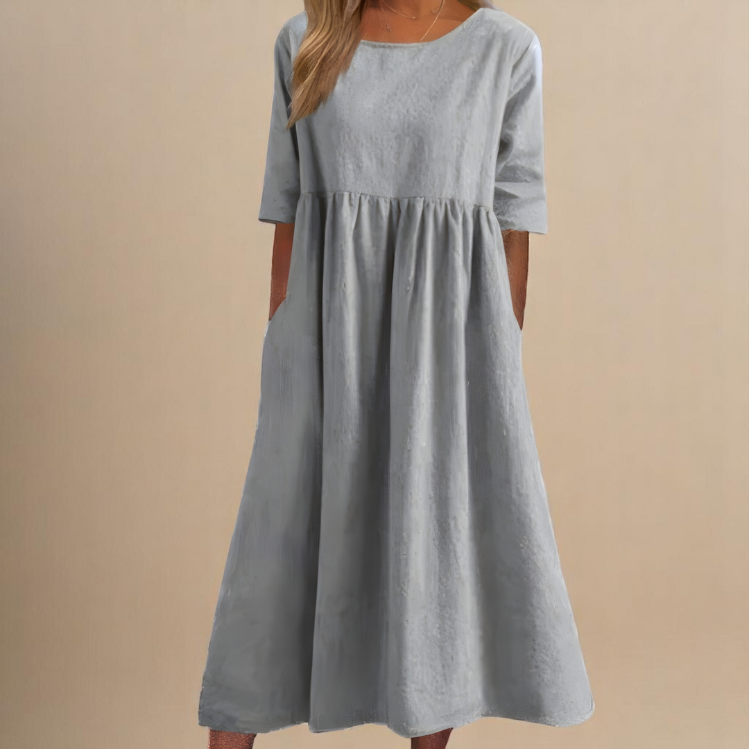 Light grey midi dress featuring relaxed fit and gathered waistline