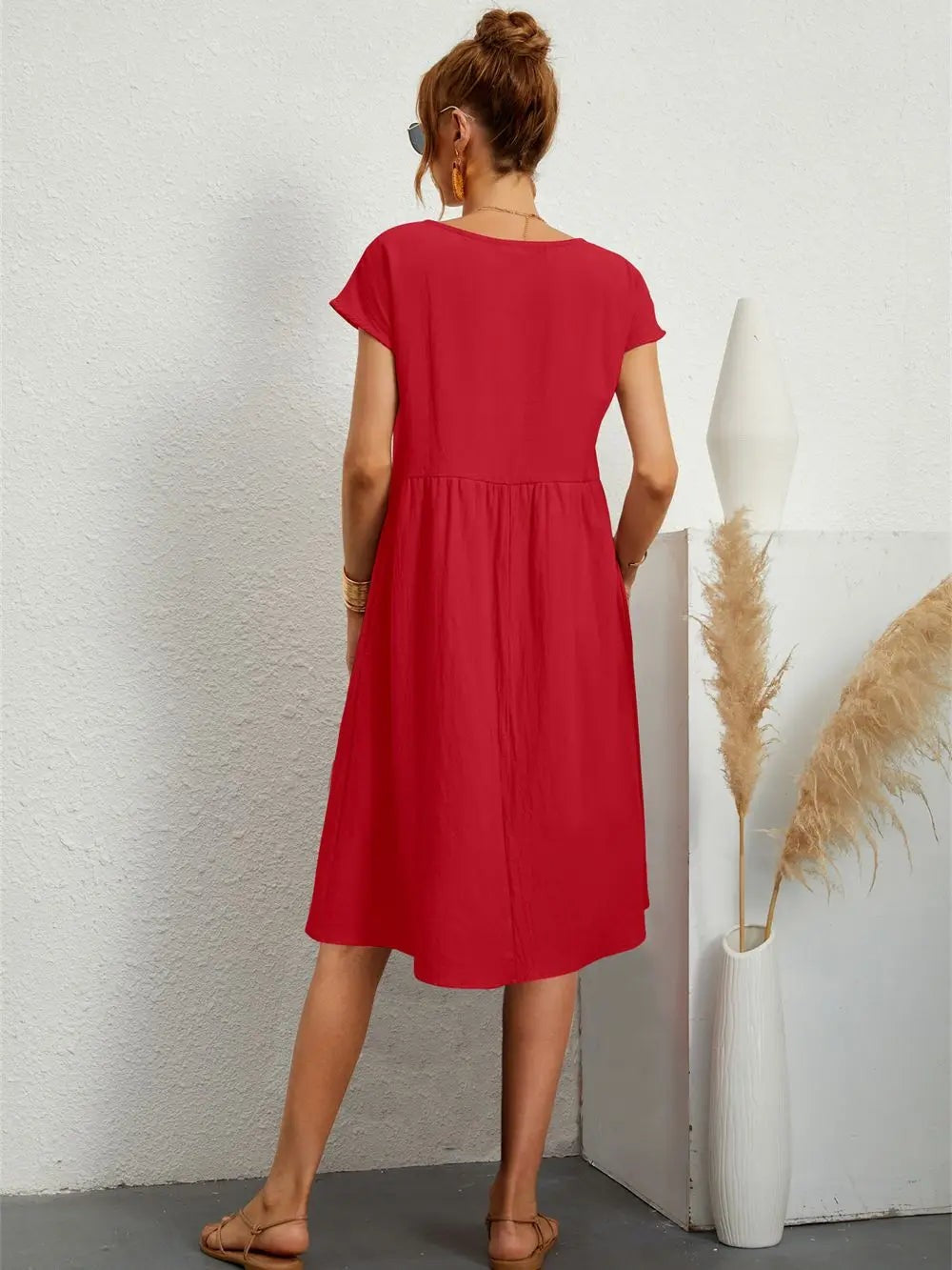Rear view of red midi dress showing loose gathered skirt and relaxed fit