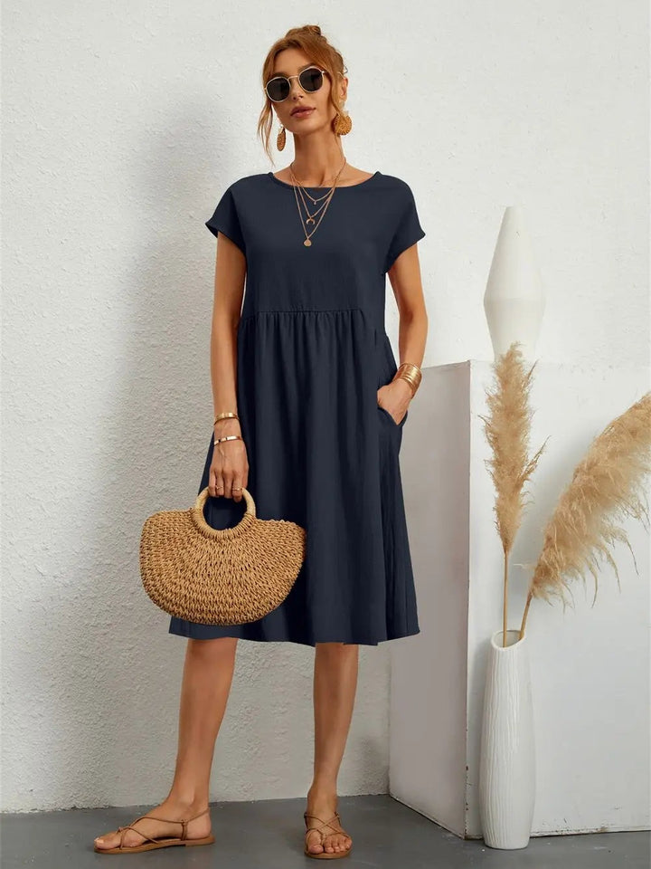 Navy midi dress with short sleeves and side pockets in a relaxed fit