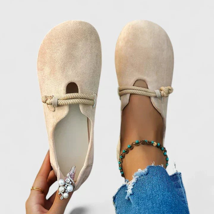Beige suede loafers with knotted rope trim and round toe design