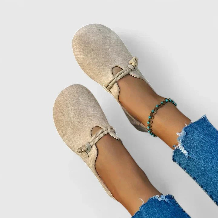 Beige suede slip-on loafers featuring cut-out vamp and rope tie detail
