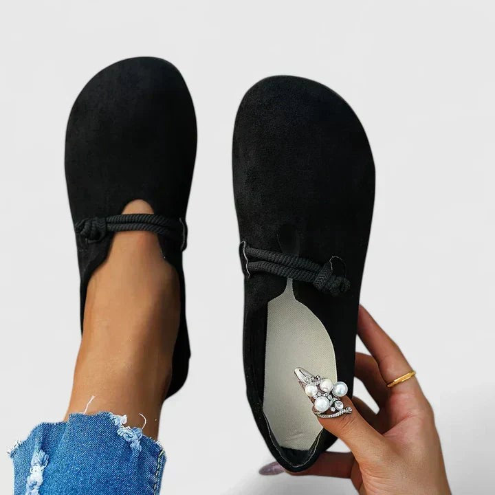 Black suede loafers held together showing soft cushioned insole