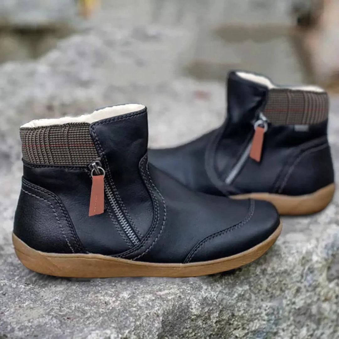 Black leather ankle boots featuring checked cuff and tan sole