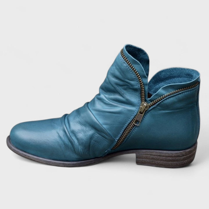 Teal leather ankle boot with brass side zip and ruched toe