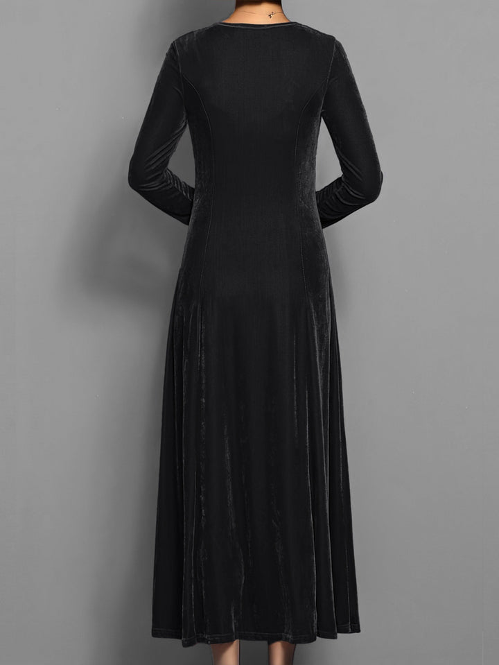 Black velvet maxi dress showing seamed A-line skirt from behind