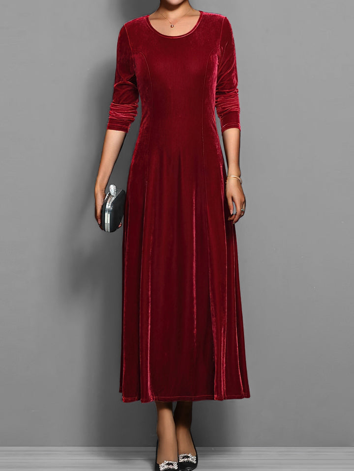 Deep red velvet maxi dress with fitted bodice and long sleeves, front view