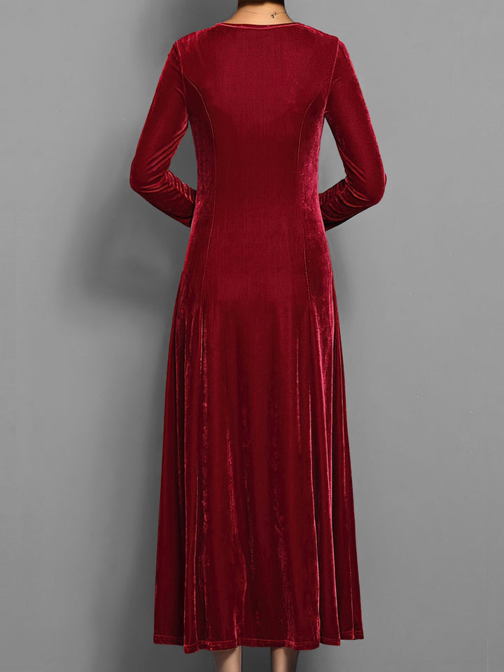 Wine red velvet maxi dress displaying flared silhouette from the back