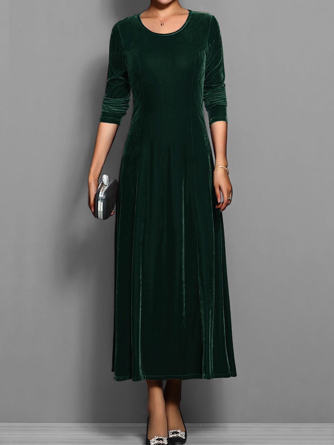 Emerald green velvet maxi dress with round neck and long sleeves, front view