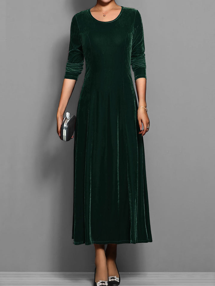 Emerald green velvet maxi dress with round neck and long sleeves, front view