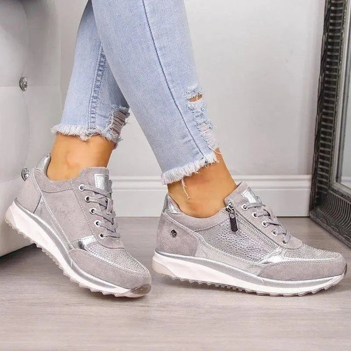 Silver sparkly trainers with side zip worn with ripped skinny jeans