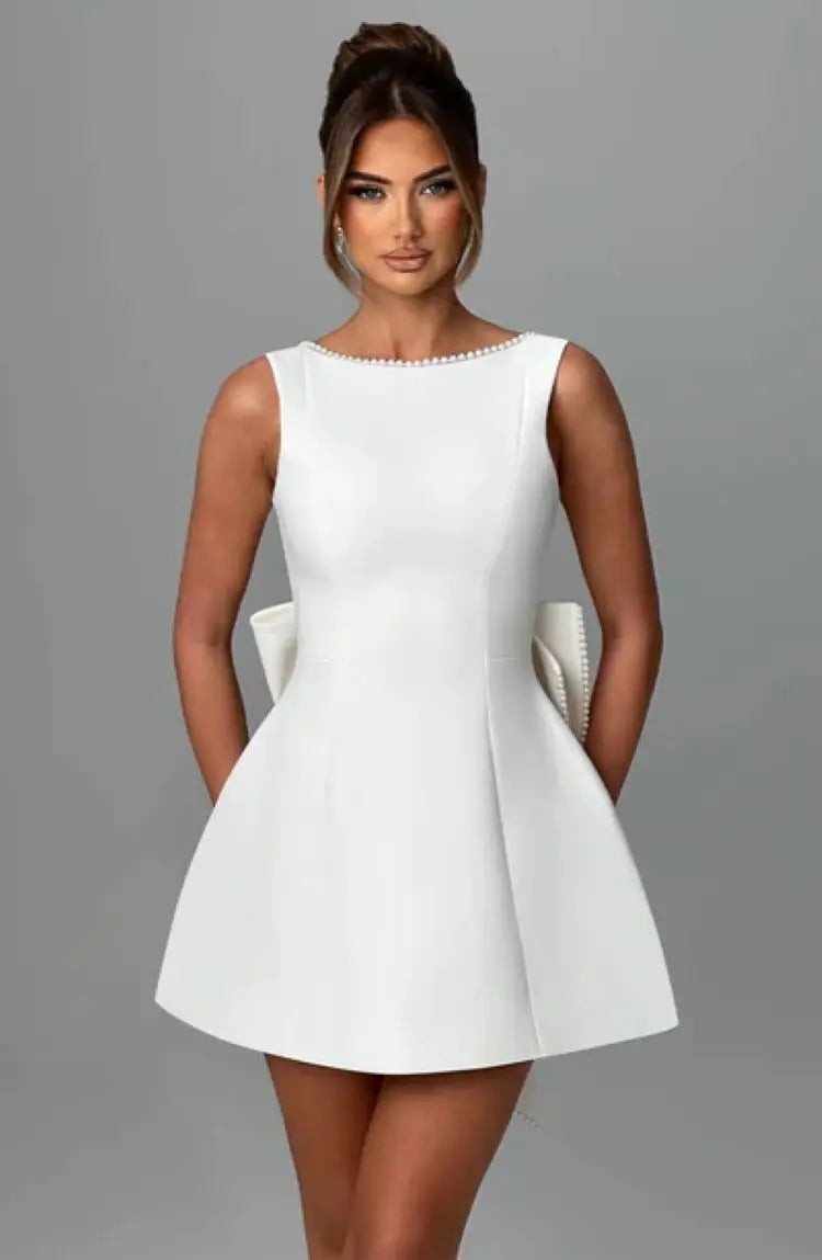 White sleeveless skater dress with pearl beaded neckline and bow