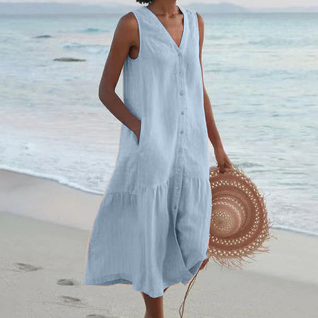 Pale blue sleeveless midi dress with button front, styled for a coastal walk