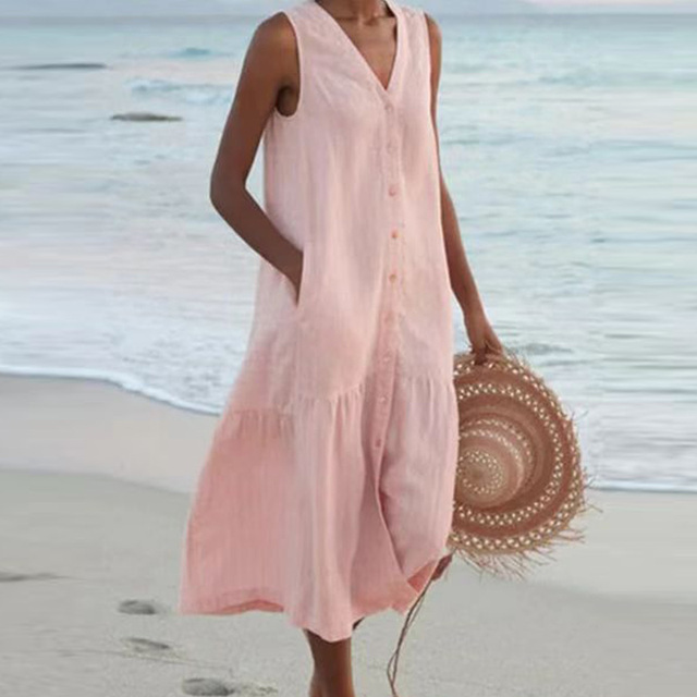Soft pink linen-look midi dress with V-neckline, shown on a sandy shore