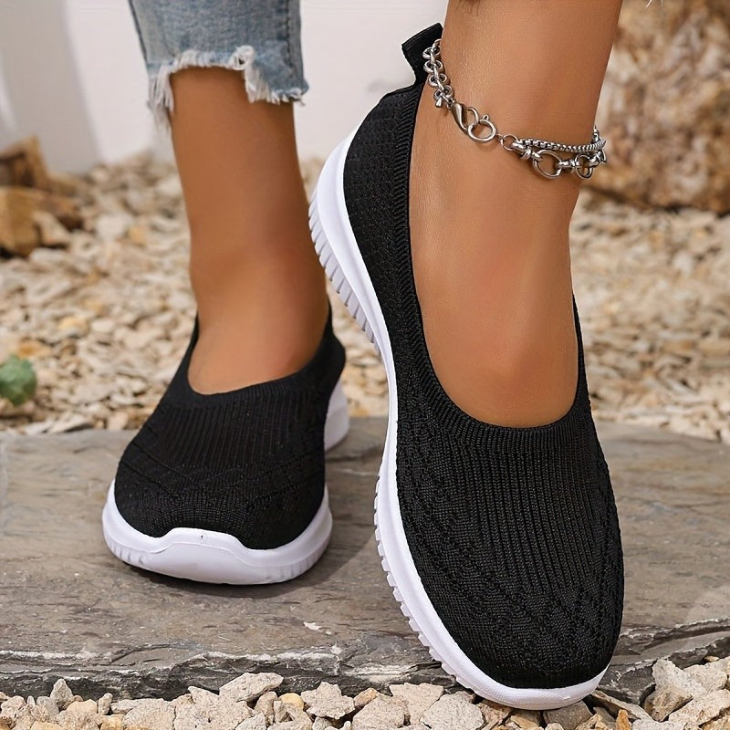 Black mesh slip-on sneakers featuring chunky white platform sole