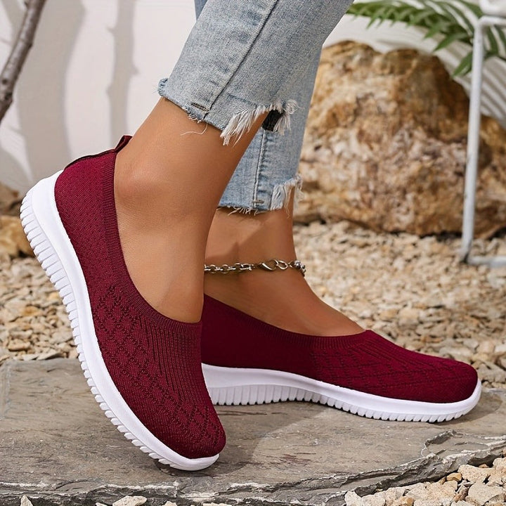 Burgundy knitted slip-on trainers paired with white ridged sole