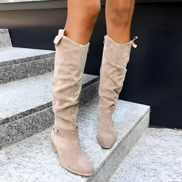 Beige suede knee boots with slouched folds and buckle fastening