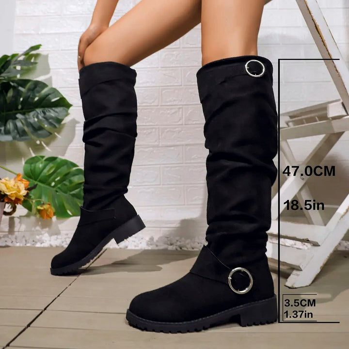 Black slouchy knee-high boots with round buckle detail and chunky sole