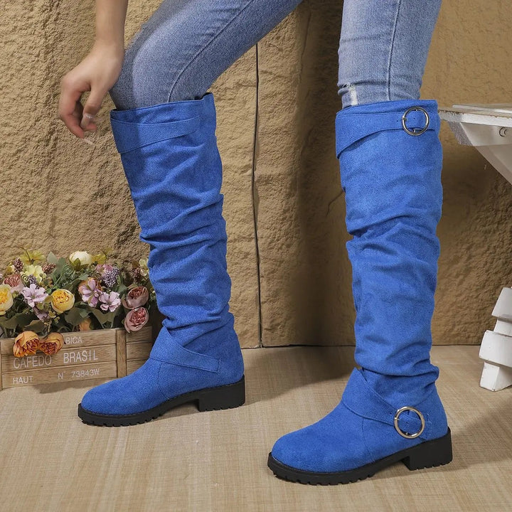 Blue suede knee-high boots with slouchy shaft and silver circular buckle