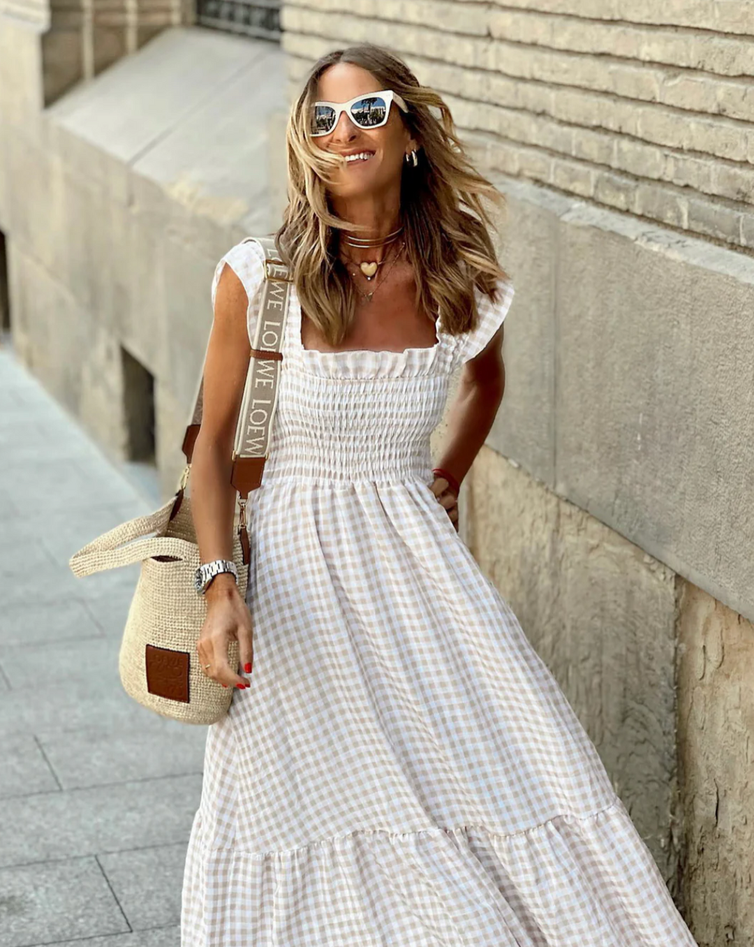 Beige gingham maxi dress with ruffled straps and smocked bodice, close-up view
