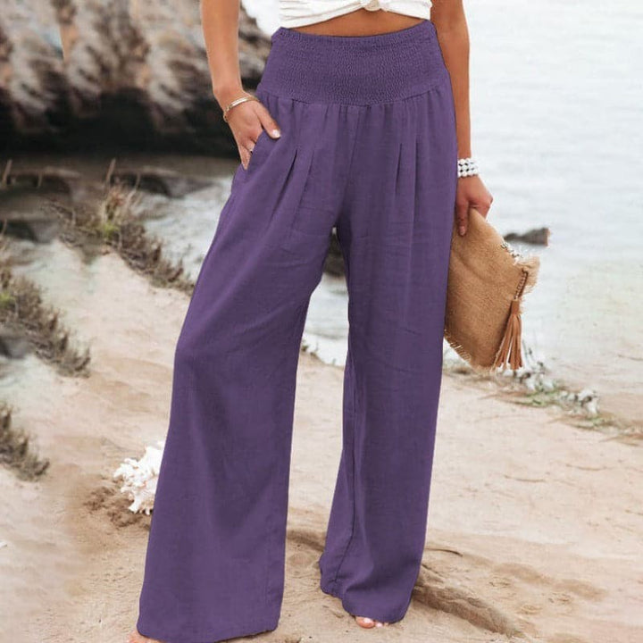 Purple wide-leg trousers featuring smocked elasticated waistband and pockets
