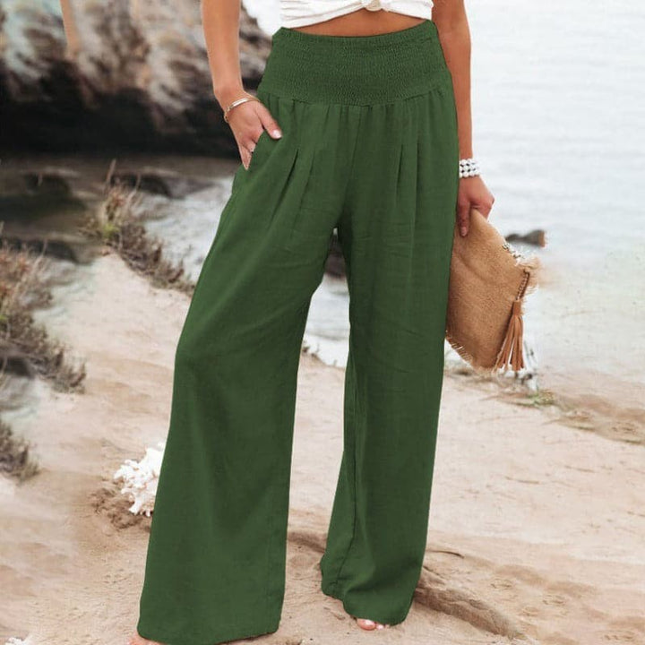 Olive green wide-leg trousers with high smocked waist and flowing fit