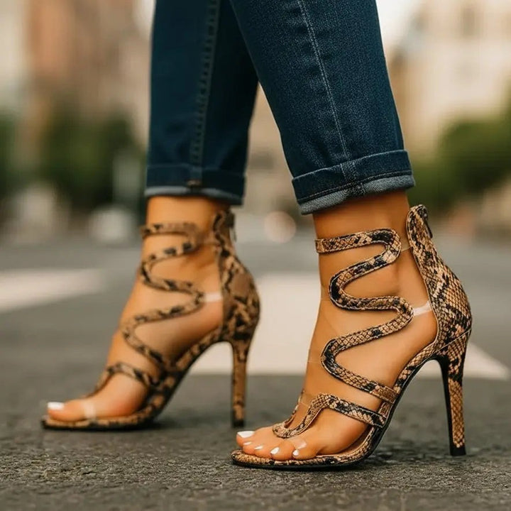Snake print strappy high heel sandals with clear vinyl straps and wavy design