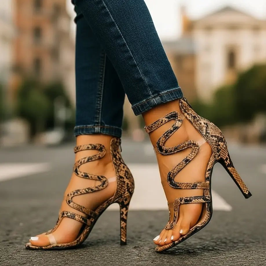 Brown snake print stiletto sandals featuring squiggle strap detailing on ankle