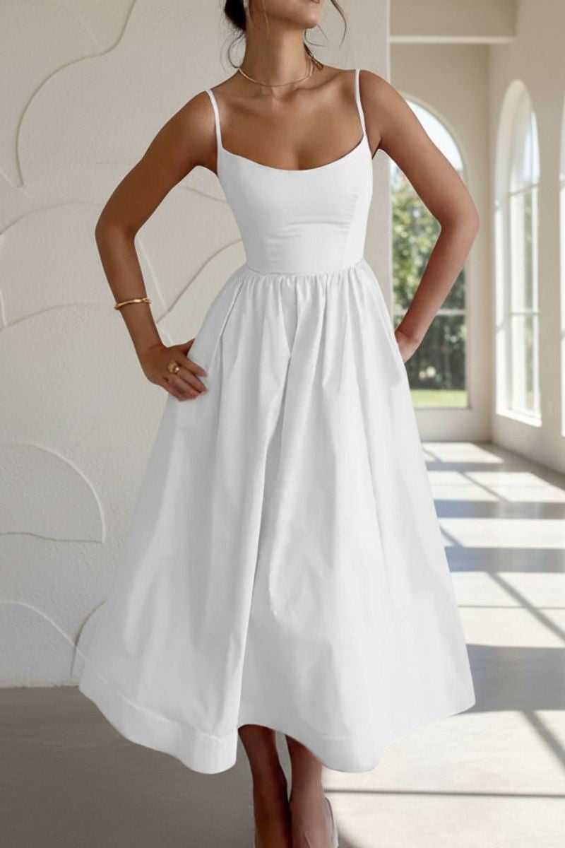 Close-up of white cocktail midi dress with scoop neckline and spaghetti straps