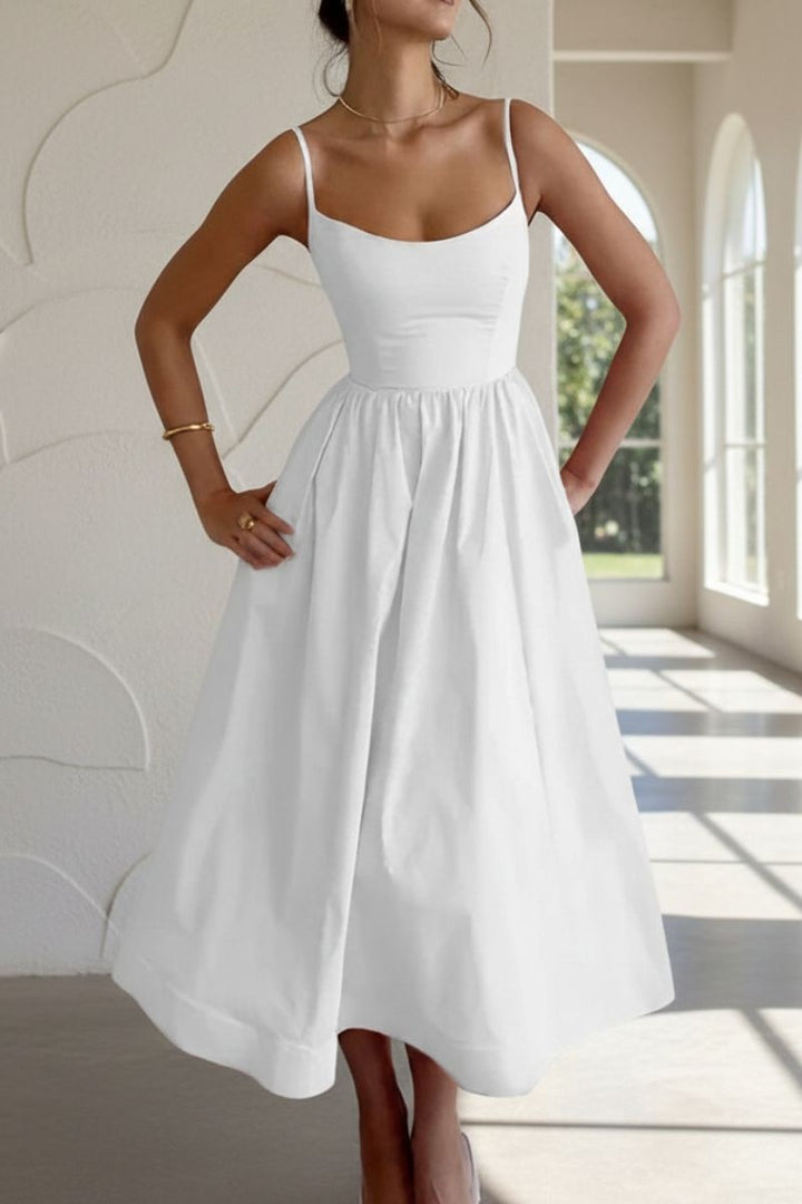Close-up of white cocktail midi dress with scoop neckline and spaghetti straps