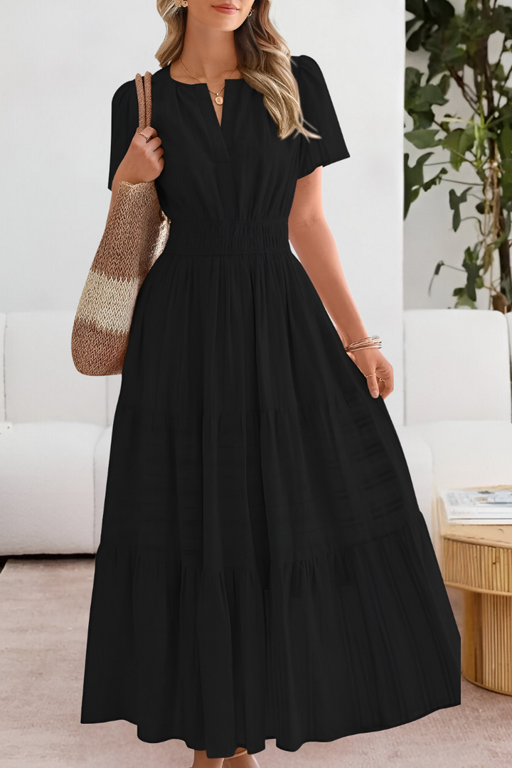 Black tiered maxi dress featuring split neckline and short puff sleeves
