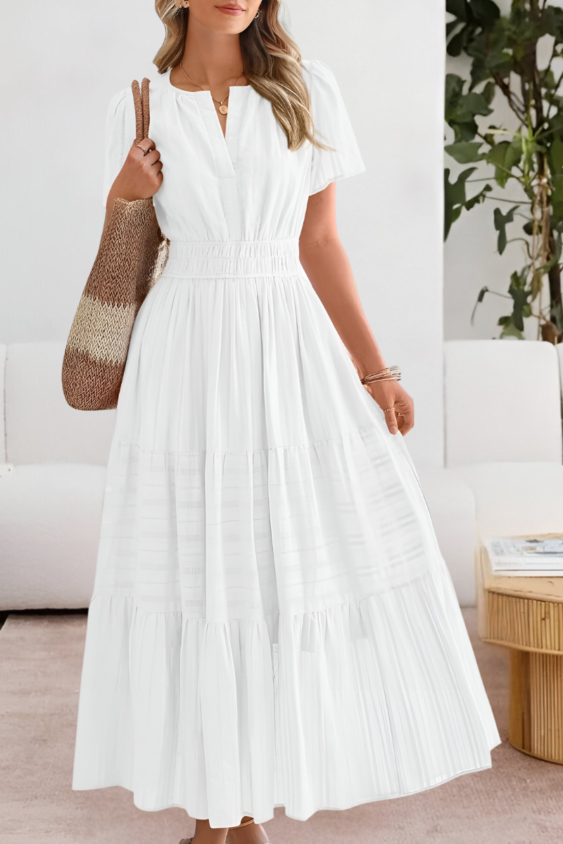 White tiered maxi dress featuring split neckline and puff sleeves