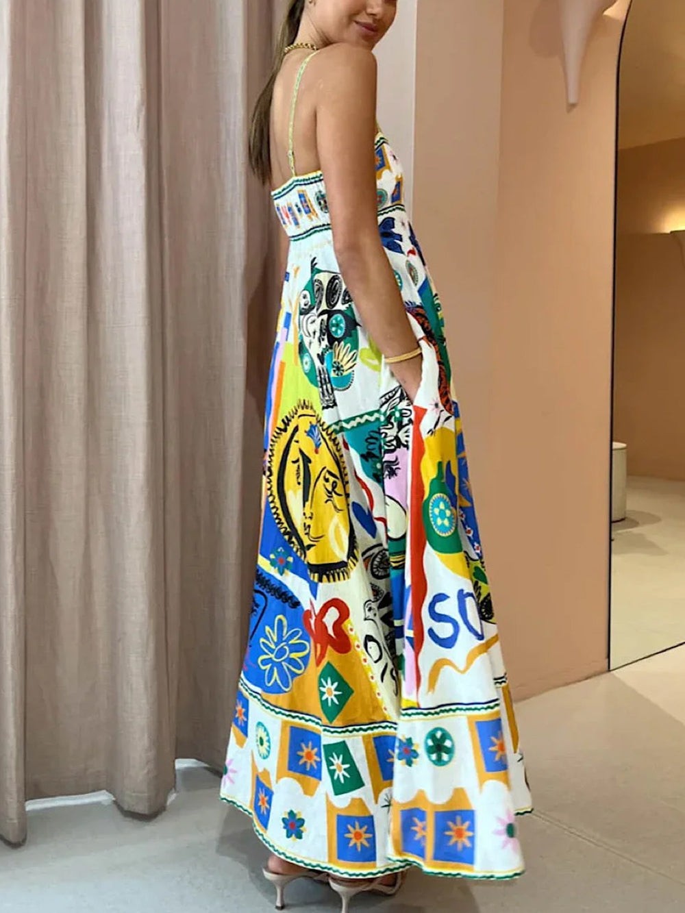 Side view of printed maxi dress showing flared skirt with pockets