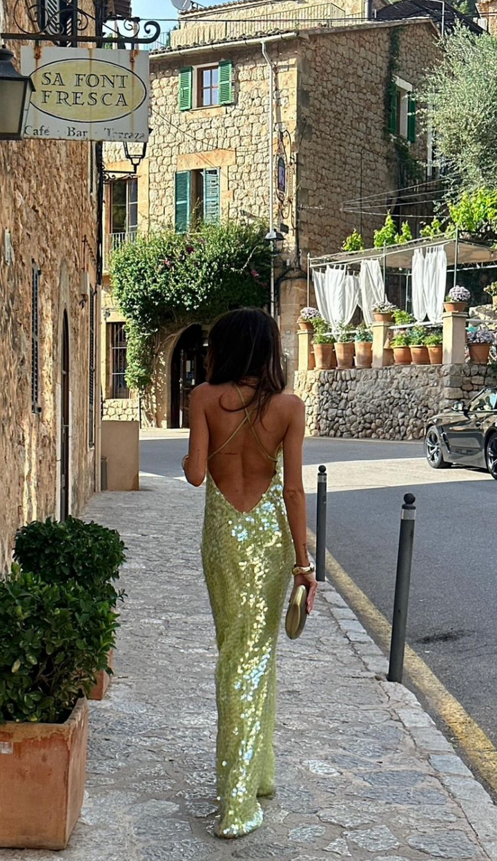 Lime green sequin gown showing low back detail, styled for a wedding guest